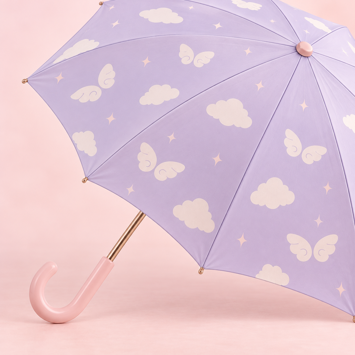 Close-up of the cloud and wing umbrella canopy with its blush handle