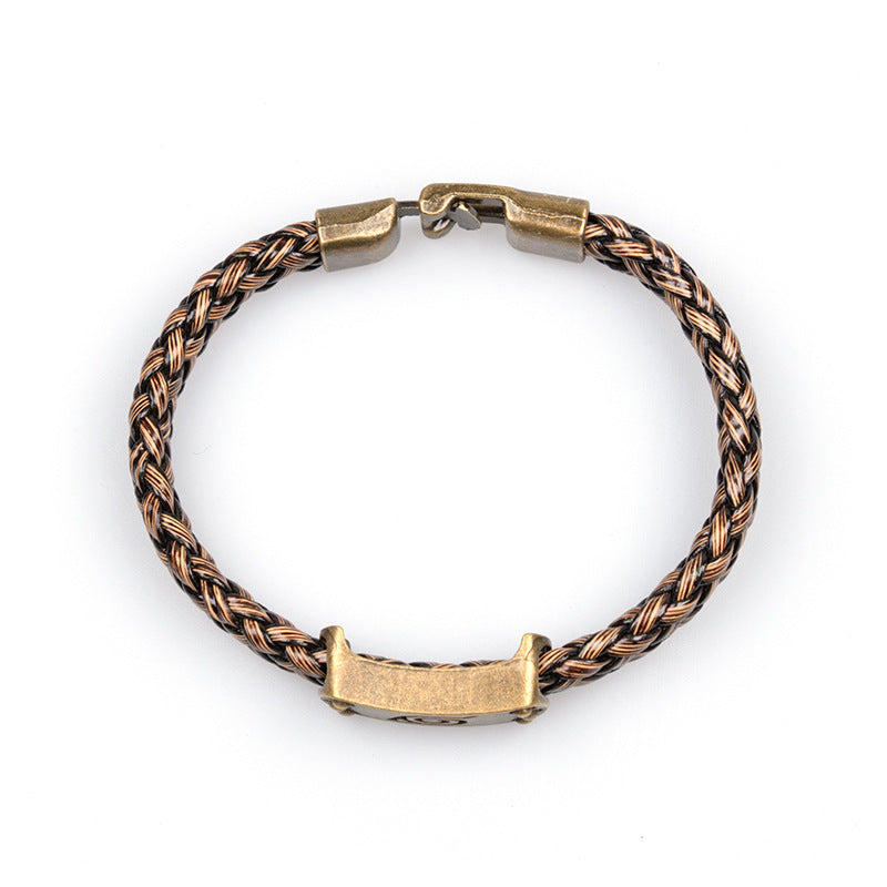 Rear view of the bronze-tone clasp and braided bracelet