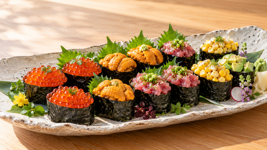 Gunkan sushi platter with ikura, uni, tuna, and vegan toppings