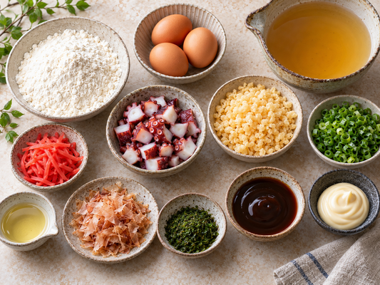 Takoyaki ingredients arranged in bowls: flour, eggs, dashi, octopus, tenkasu, scallions, ginger, and toppings