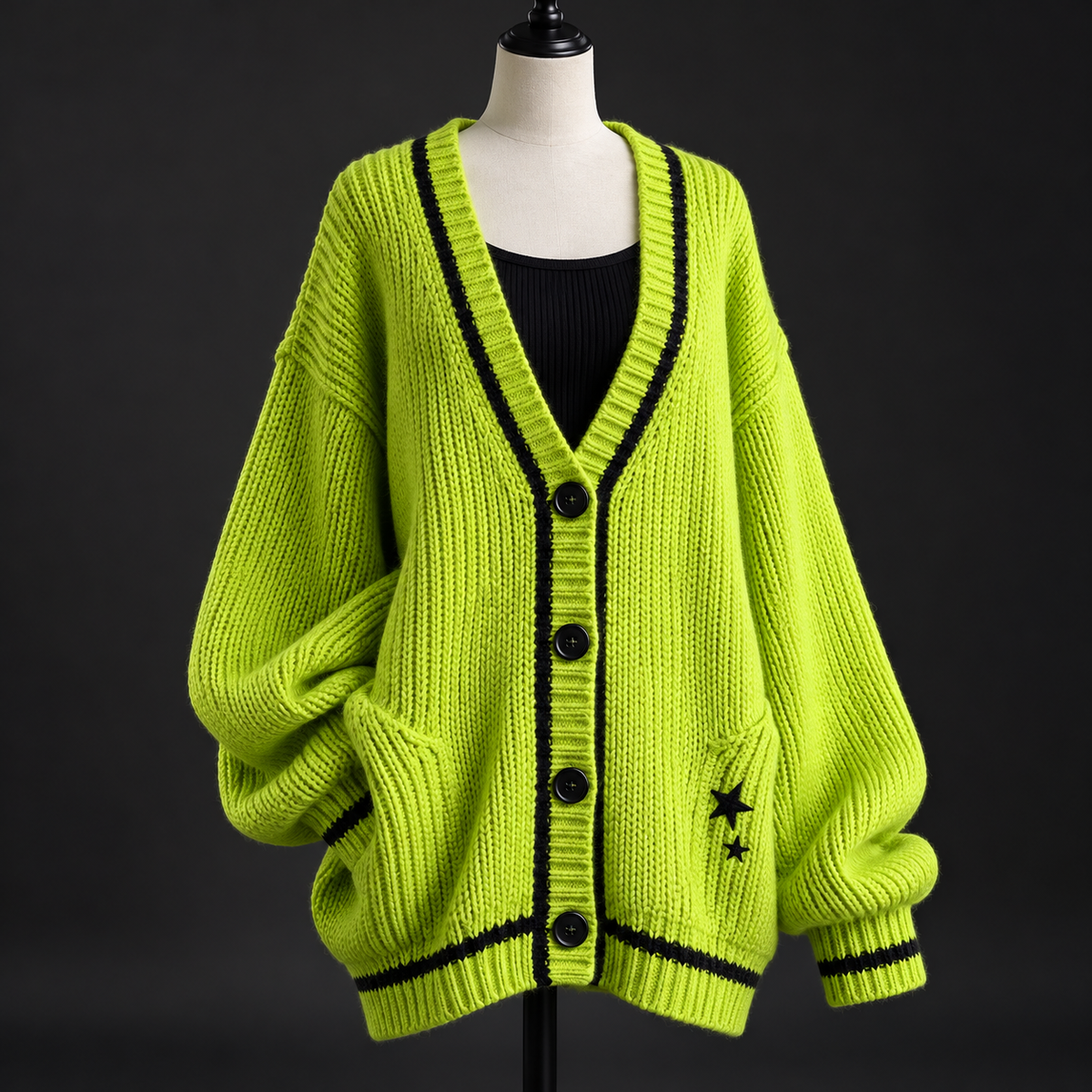 Acid-lime oversized knit cardigan with black trim and star details