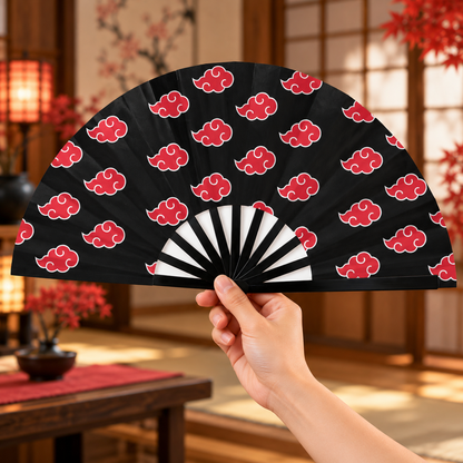 Akatsuki clouds folding fan held open in a warm Japanese-inspired interior