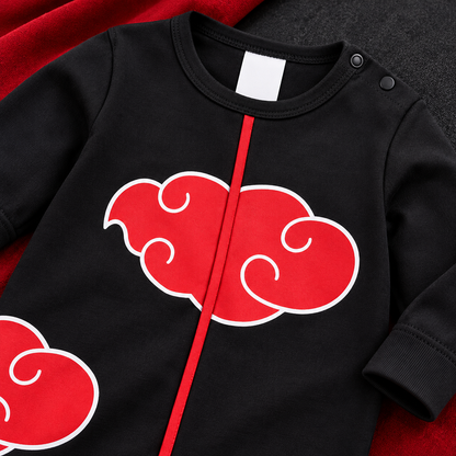 Close-up of the red cloud graphic and red trim on the black Akatsuki-inspired baby onesie