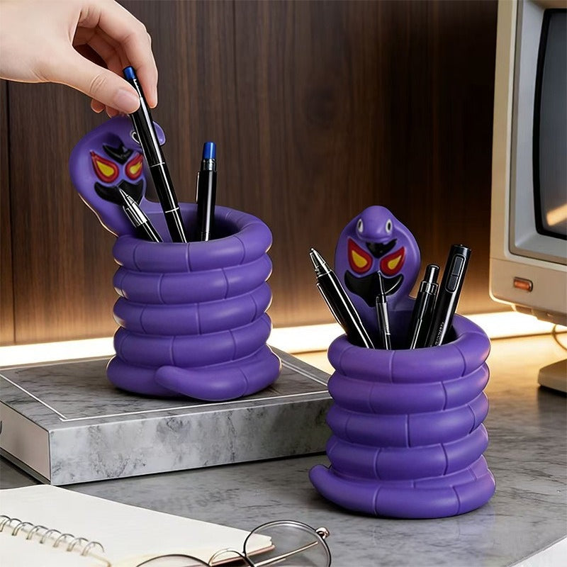 Arbok Figure Pen Holder on desk with pens