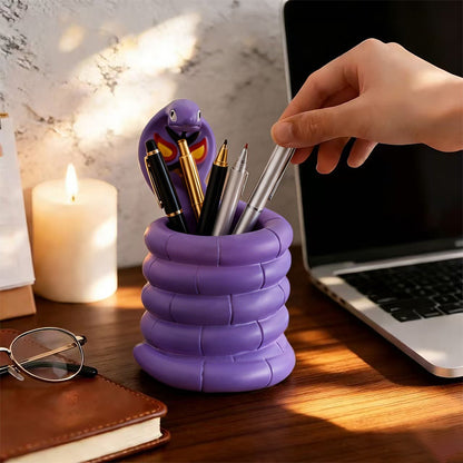 Arbok Figure Pen Holder beside laptop