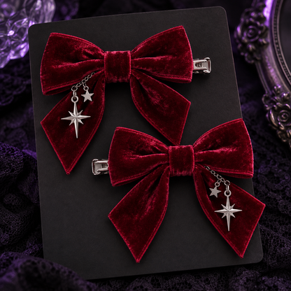 Pair of crimson velvet bow hair clips with silver star charms