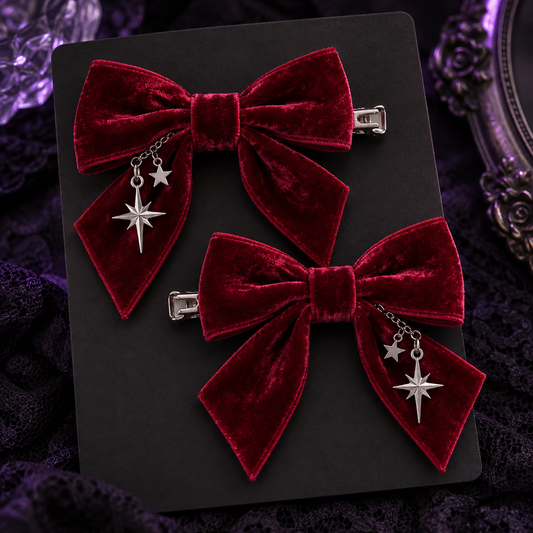 Pair of crimson velvet bow hair clips with silver star charms