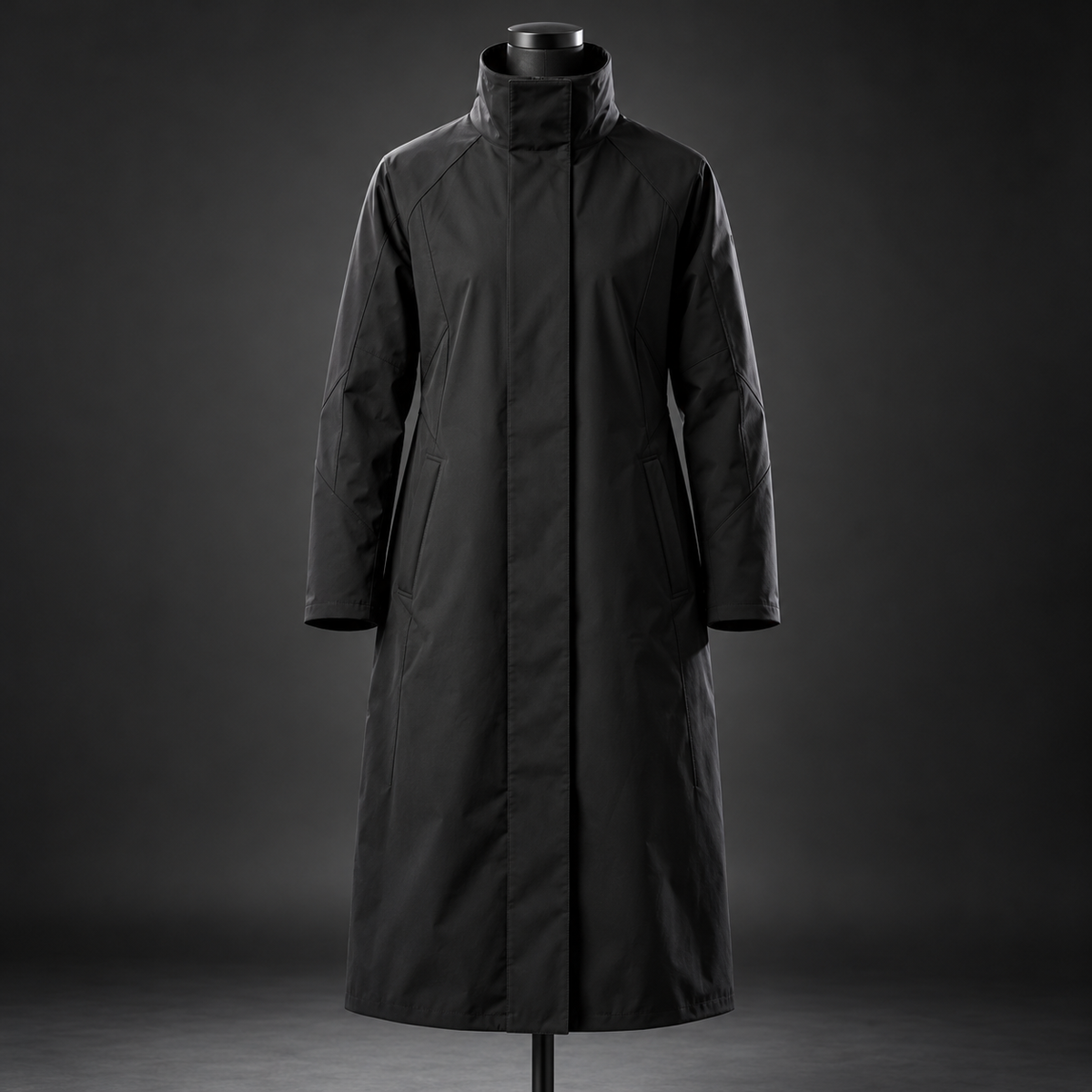 Long black techwear coat with high collar and concealed front closure