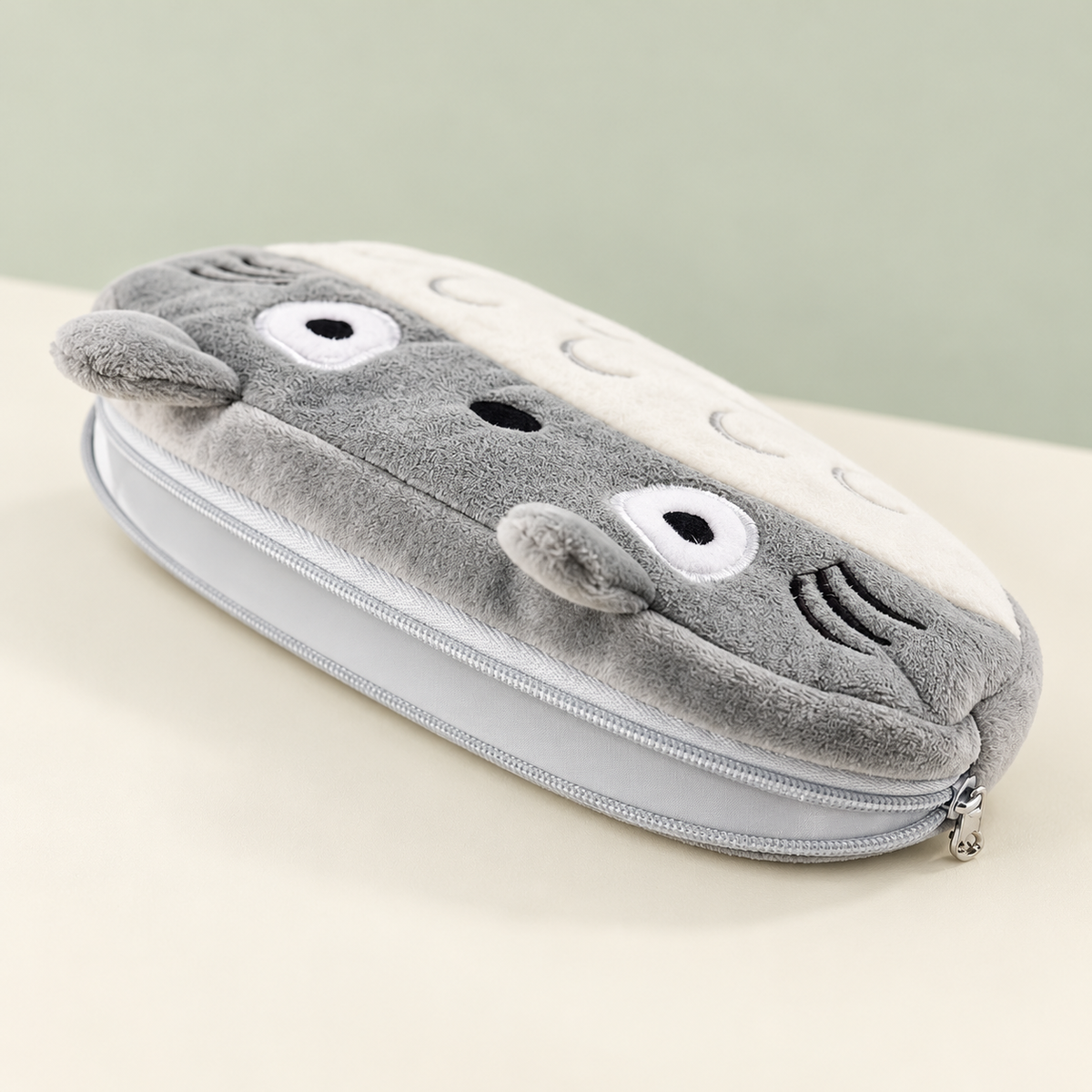 Side angle of Totoro plush pencil case showing zipper