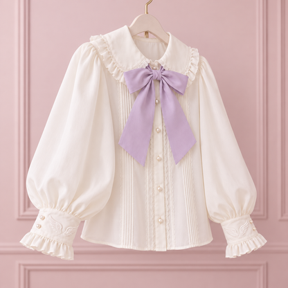 Angled view of the ivory angelic blouse with a lilac bow