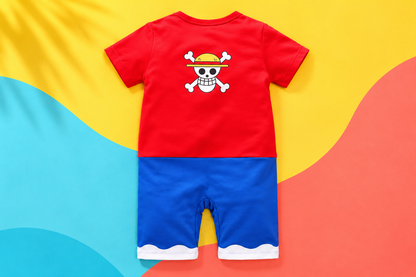 Vibrant back view of the Luffy-inspired baby romper on a yellow, aqua, and coral background