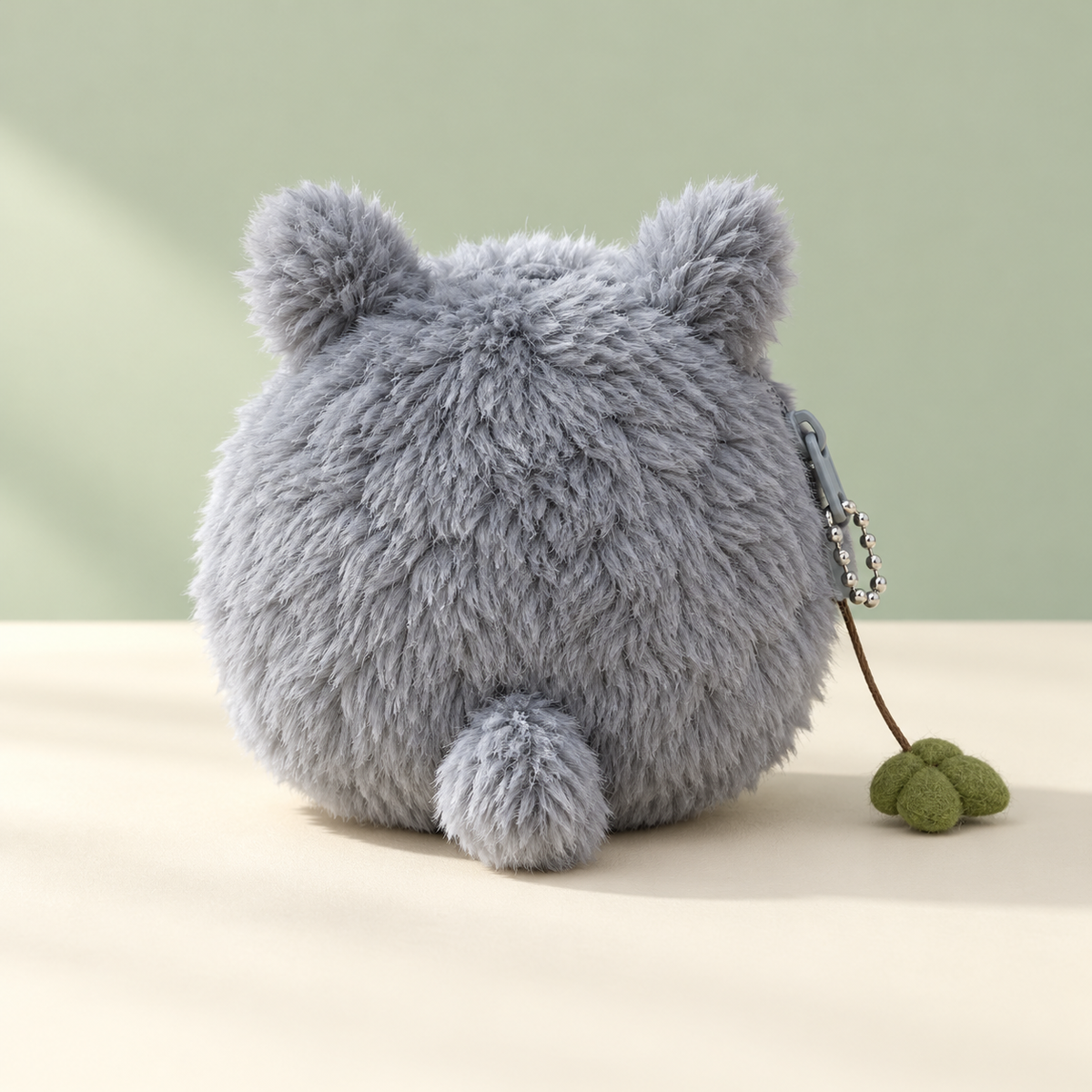 Back of gray Totoro plush keychain wallet with leaf charm