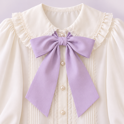 Close-up of the lilac bow and buttons on the ivory blouse