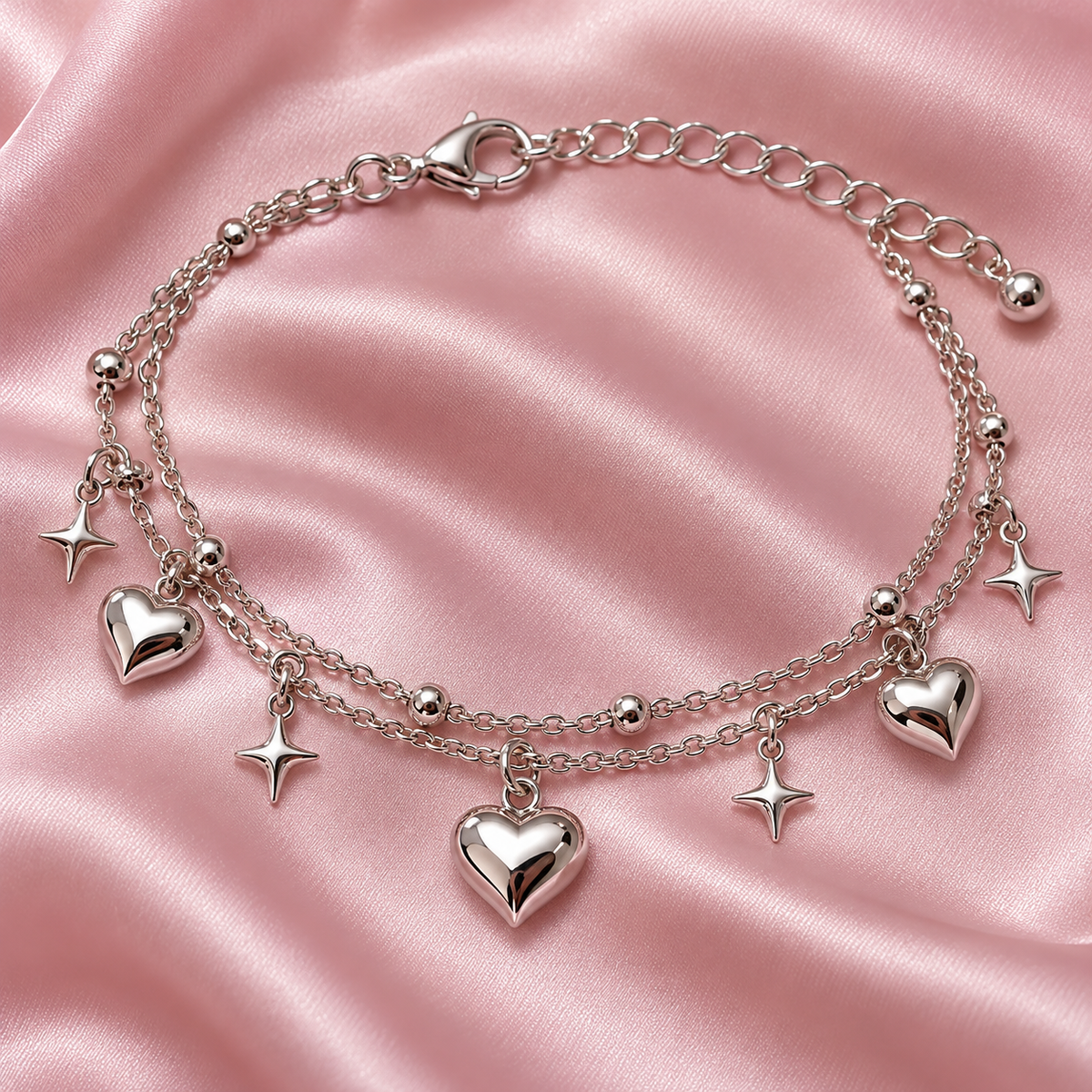 Close-up of silver heart and star charms on the Gyaru anklet