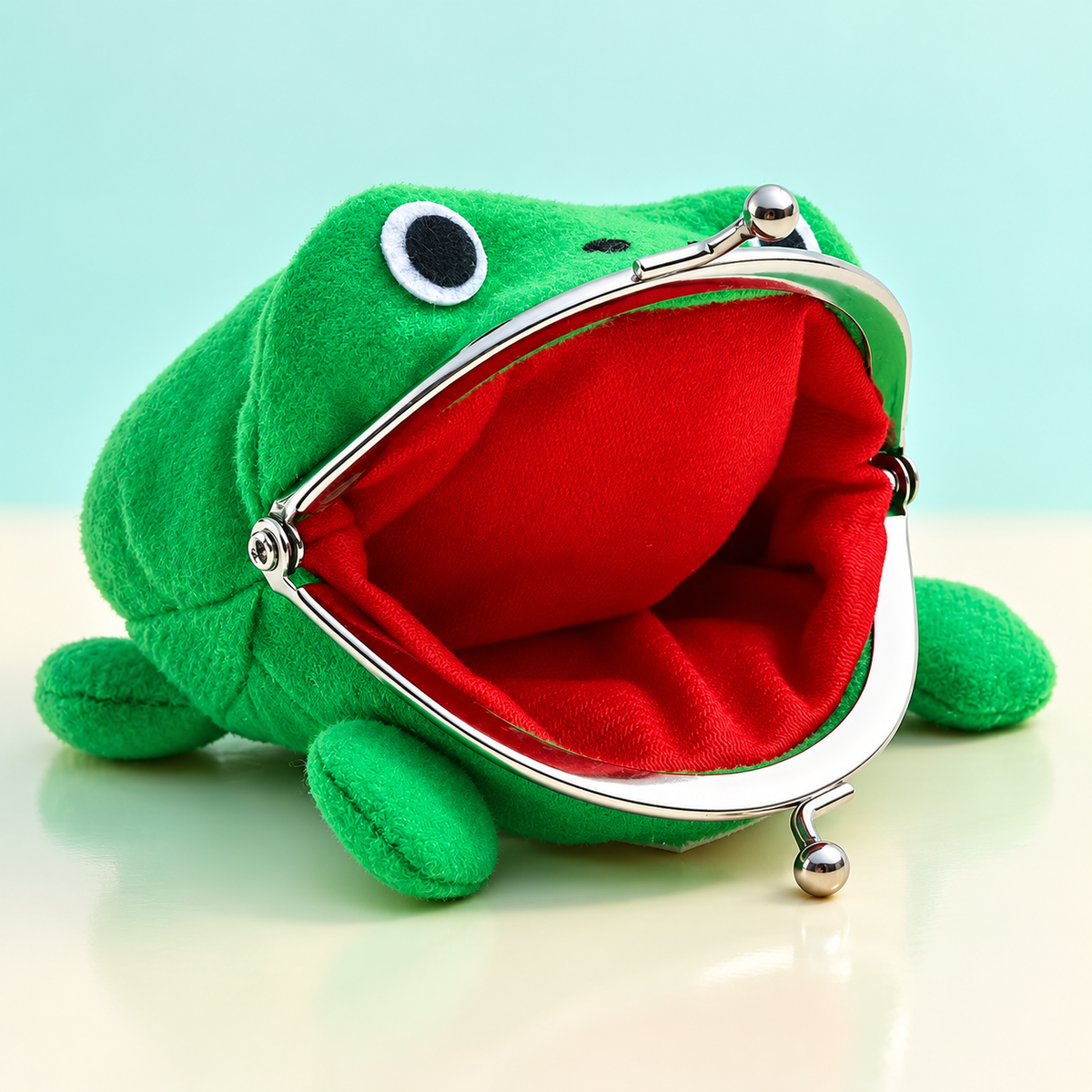 Open Gama-Chan plush frog wallet showing the vivid red lining and silver clasp