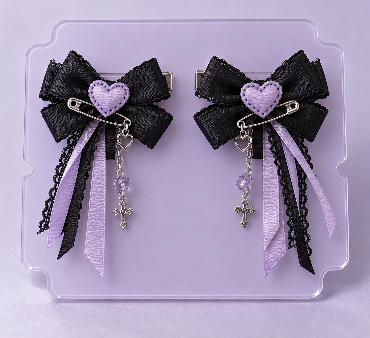 Pair of black and lavender Yami Kawaii bow hair clips with heart stitching