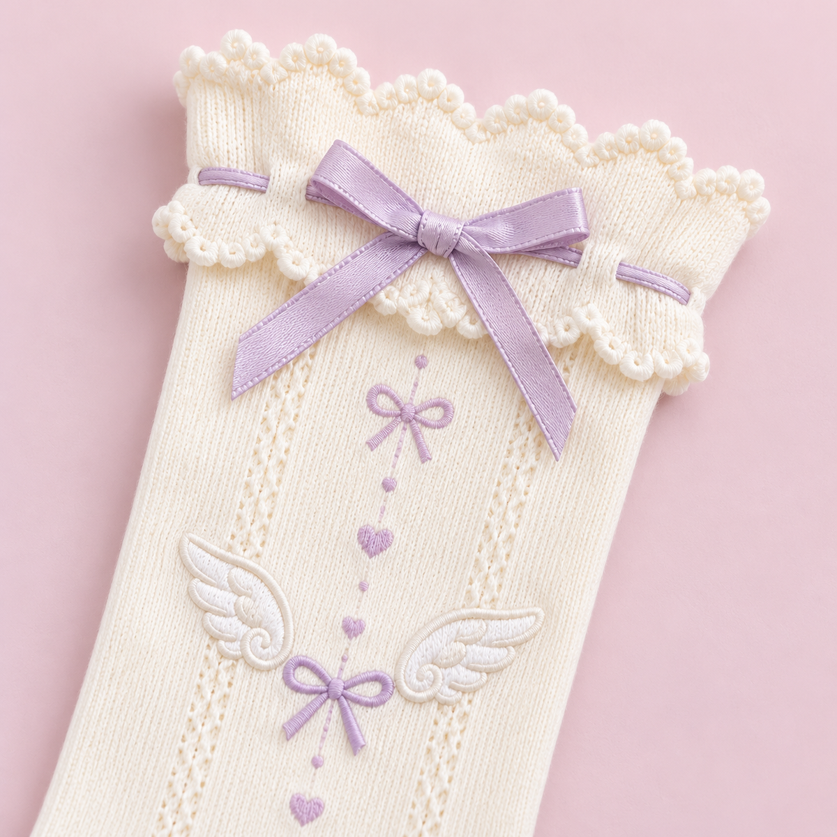 Close-up of the lilac bow and scalloped cuff on the ivory socks