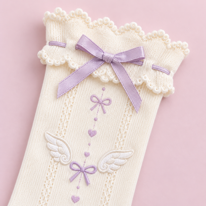 Close-up of the lilac bow and scalloped cuff on the ivory socks
