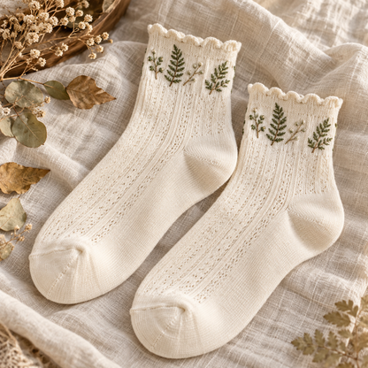 Pair of cream Mori Kei ankle socks with green fern embroidery and scalloped cuffs