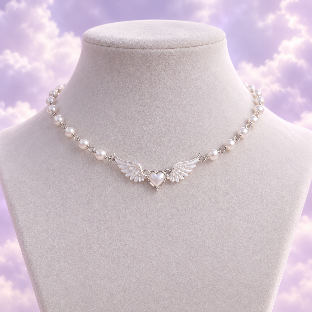 Silver tone pearl choker with a tiny heart framed by angel wings