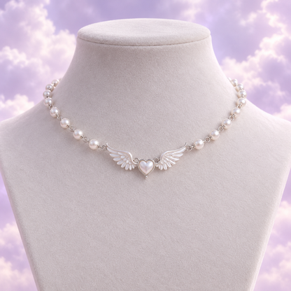 Silver tone pearl choker with a tiny heart framed by angel wings