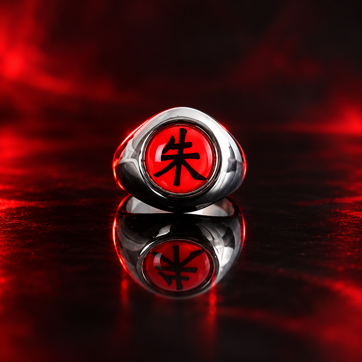 Itachi Shu Akatsuki ring in silver tone with scarlet 朱 face on a dark red-lit display