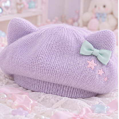 Close detail of the lavender cat-ear beret's knit, mint bow, and star embroidery