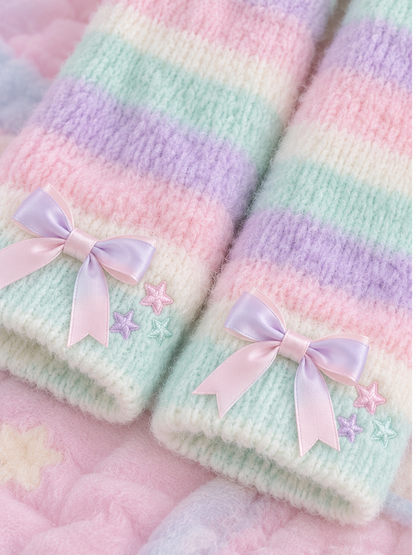 Close detail of pastel knit leg warmers with bows and star embroidery