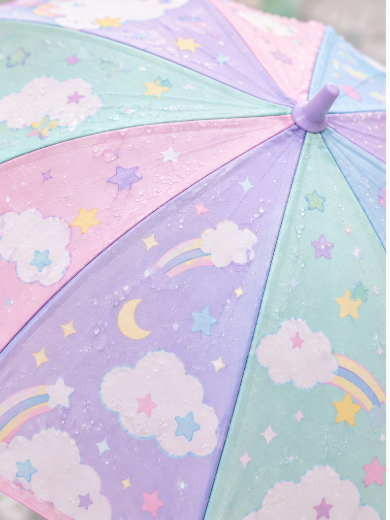 Close detail of pastel umbrella panels with cloud and star motifs
