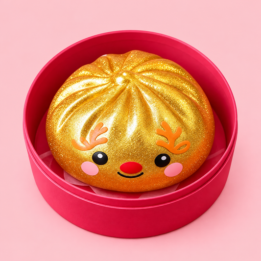 Golden Reindeer Christmas Dumpling Squishy in a pink case