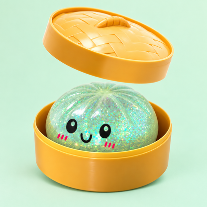 Green Glitter Dumpling Squishy in its case on a plain mint green pastel background