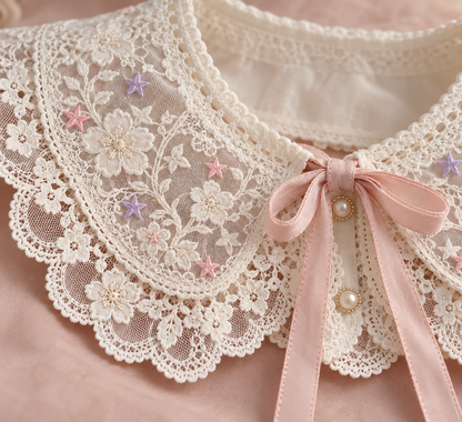 Close-up of lace embroidery, pastel stars, and ribbon tie on the Harajuku collar