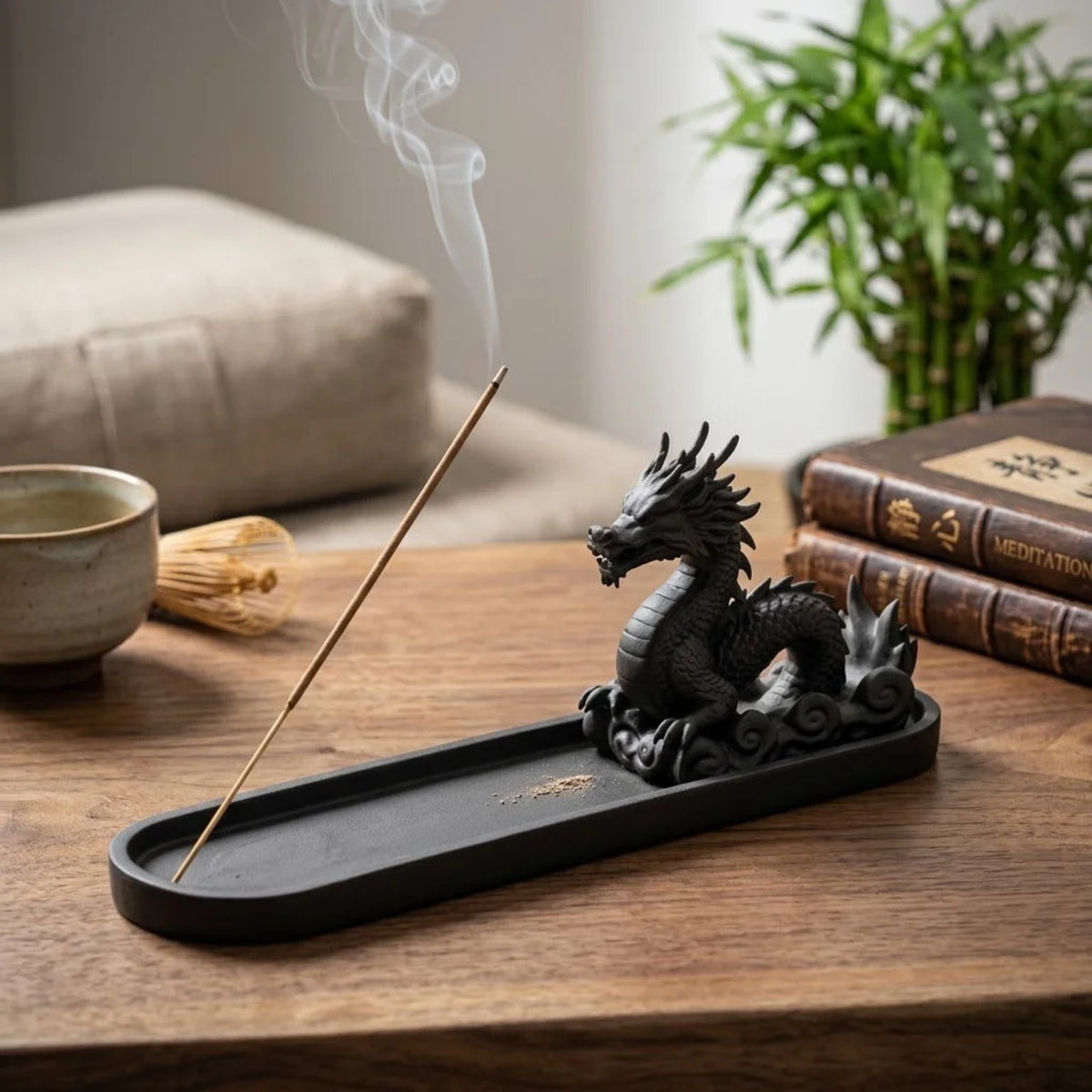 Dragon incense holder styled with tea, books, and greenery