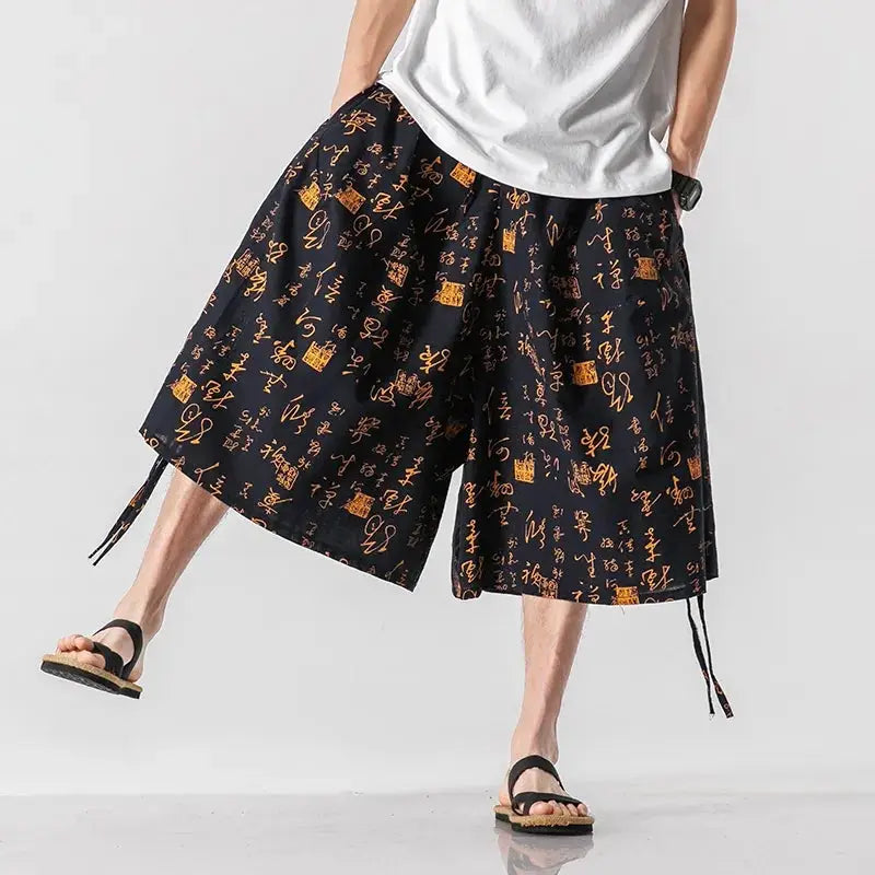 Pantalones harén con estampado kanji dorados
