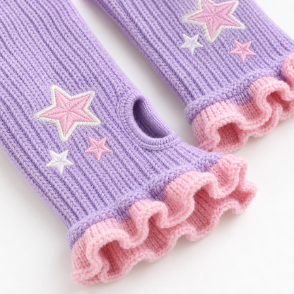 Close-up of lilac knit, pink ruffles, thumb opening, and star embroidery