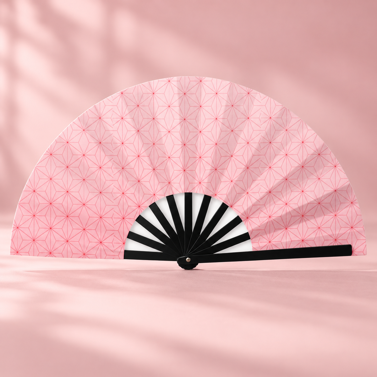 Nezuko-style folding fan displayed against a blush pink backdrop