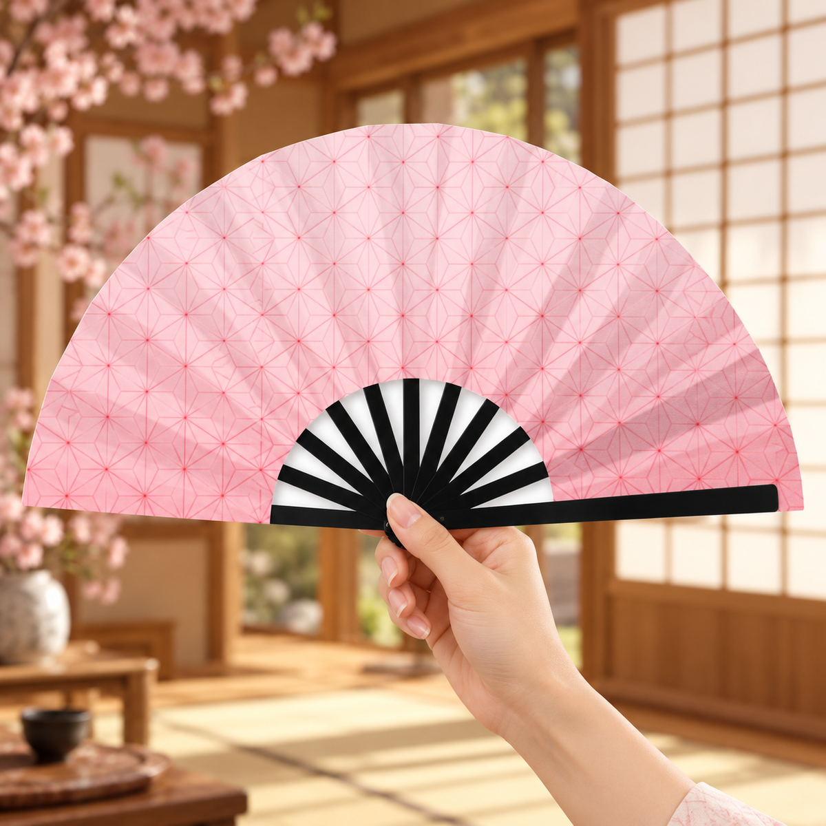 Nezuko-style pink folding fan held open in a Japanese-inspired room