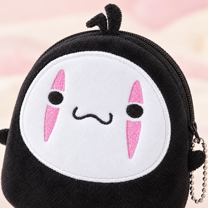 Close-up of the No Face plush wallet embroidery and soft black fabric