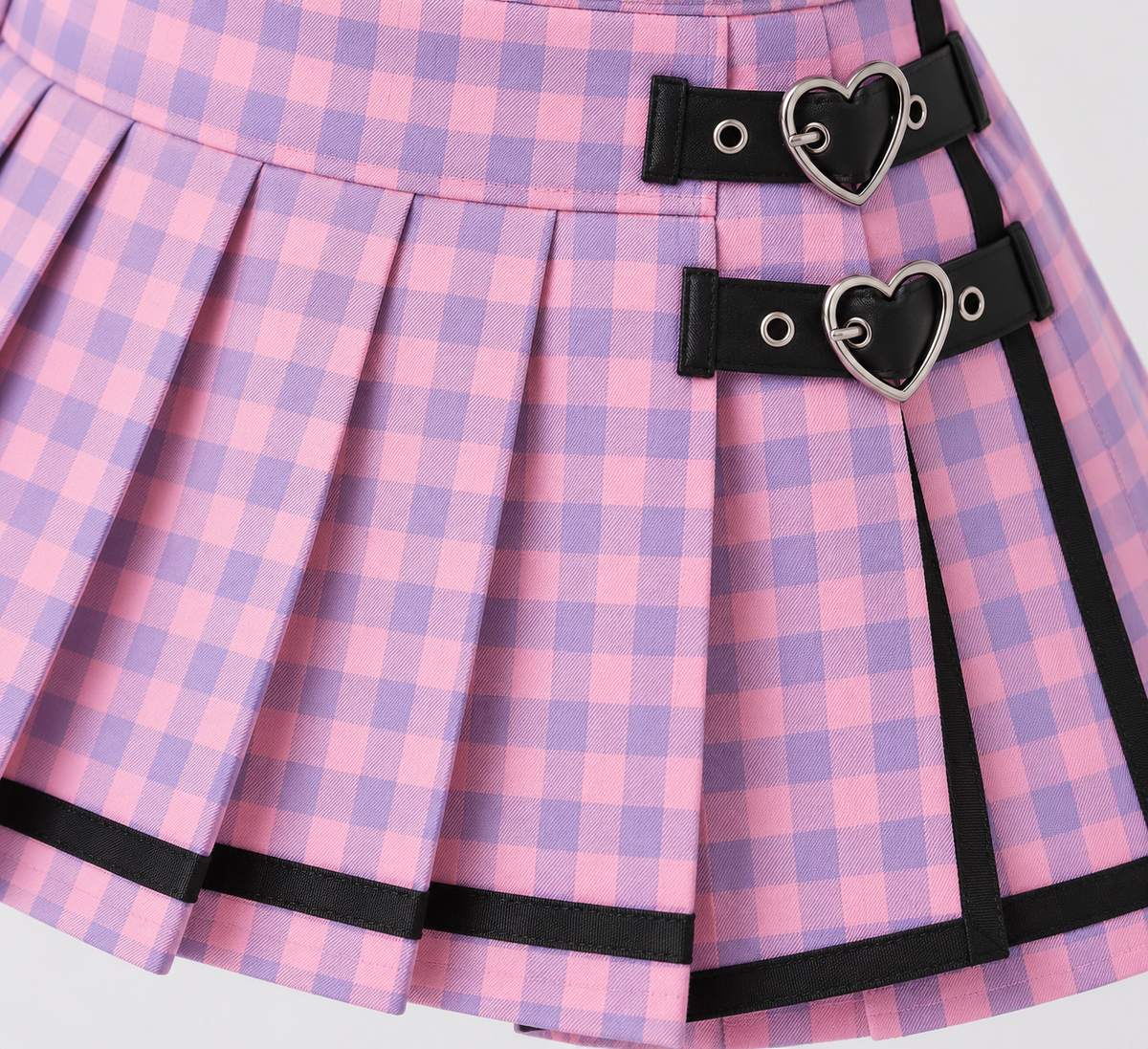 Close-up of the gingham pleats, black trim, and heart buckle