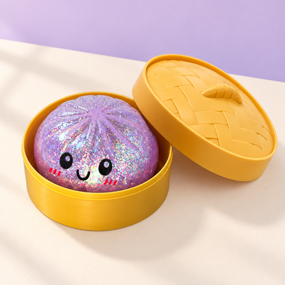 Purple glitter dumpling squishy with open gold case and lid on a lavender backdrop