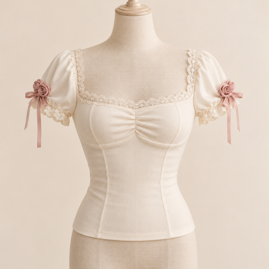 Ivory fitted top with dusty rose rosettes and lace neckline
