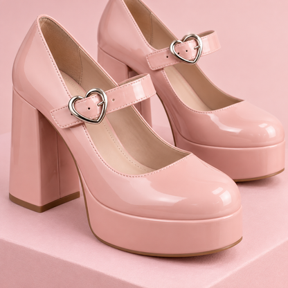 Close-up of blush Mary Jane shoe heart buckle and platform