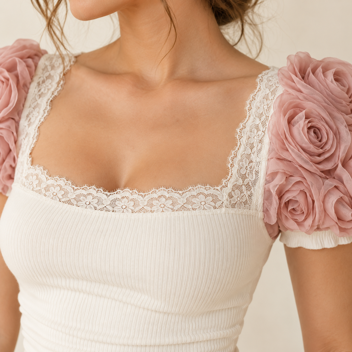 Close-up of lace neckline and rose rosette sleeve accents