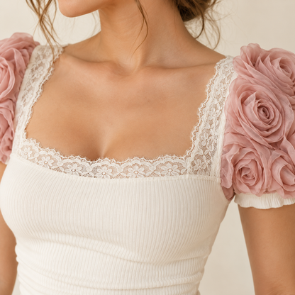 Close-up of lace neckline and rose rosette sleeve accents