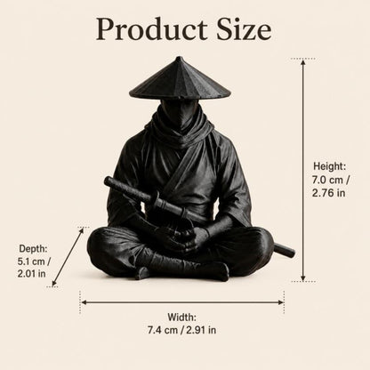 Sitting Zen Ninja Figure displayed beside a book on a wooden desk
