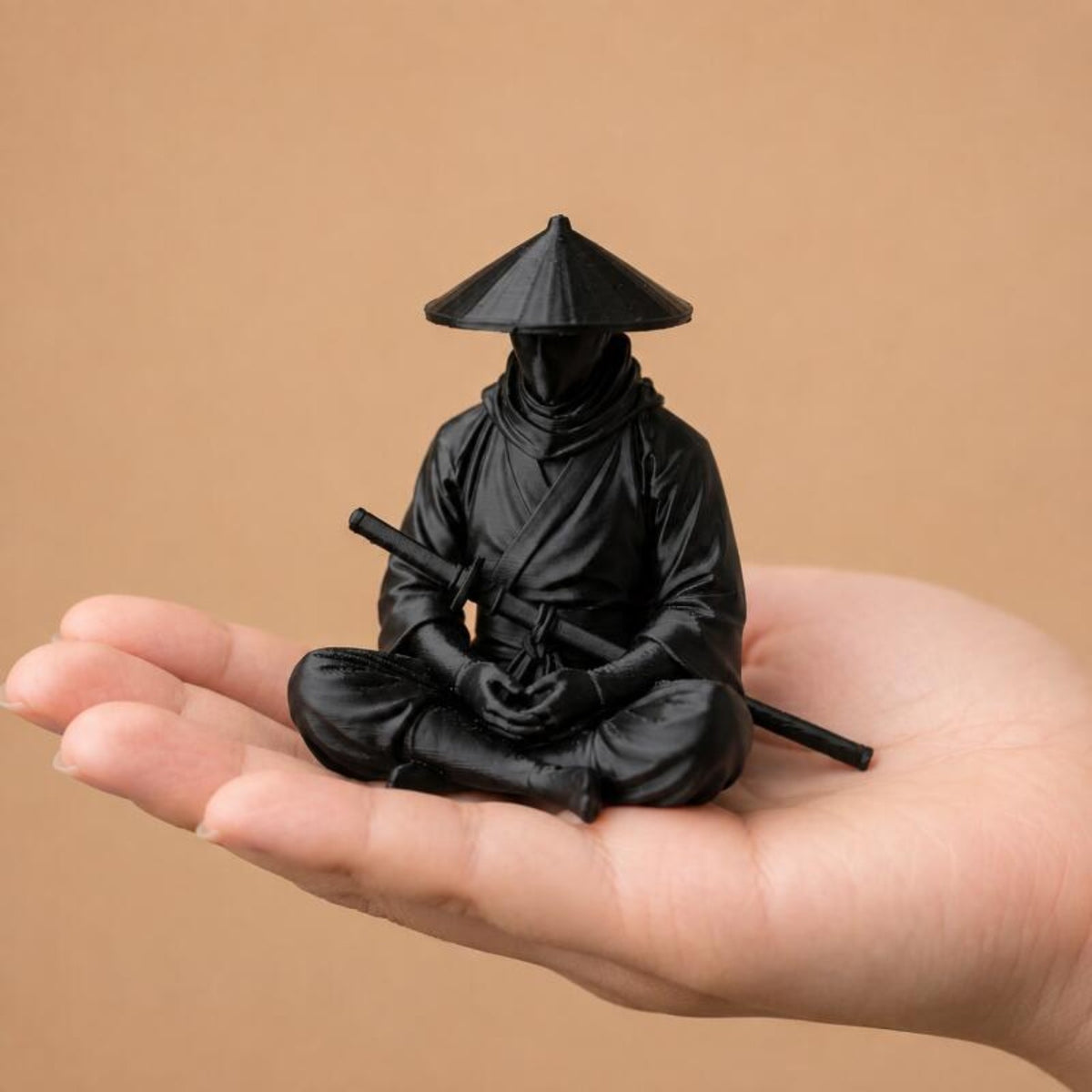 Sitting Zen Ninja Figure shown in a hand for scale