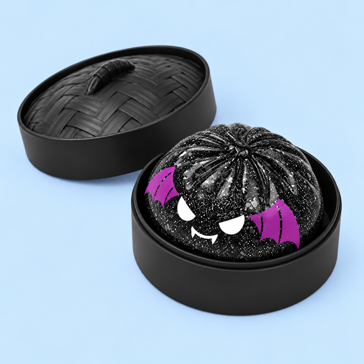 Spooky Bat Squishy and separate ridged case lid on pale blue background