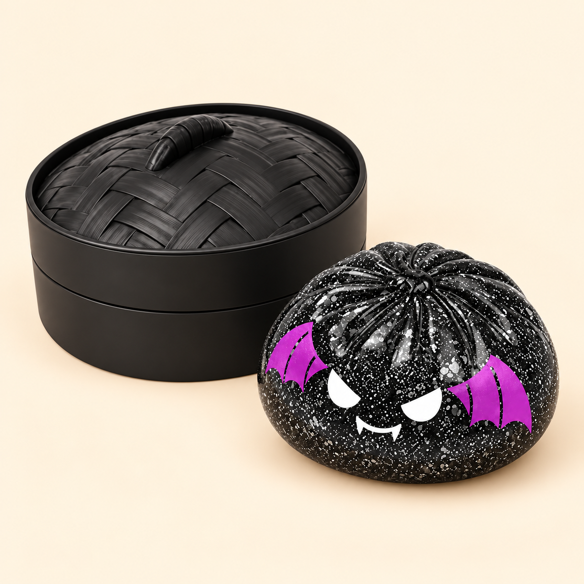 Spooky Bat Squishy beside the matching black case and lid on cream background