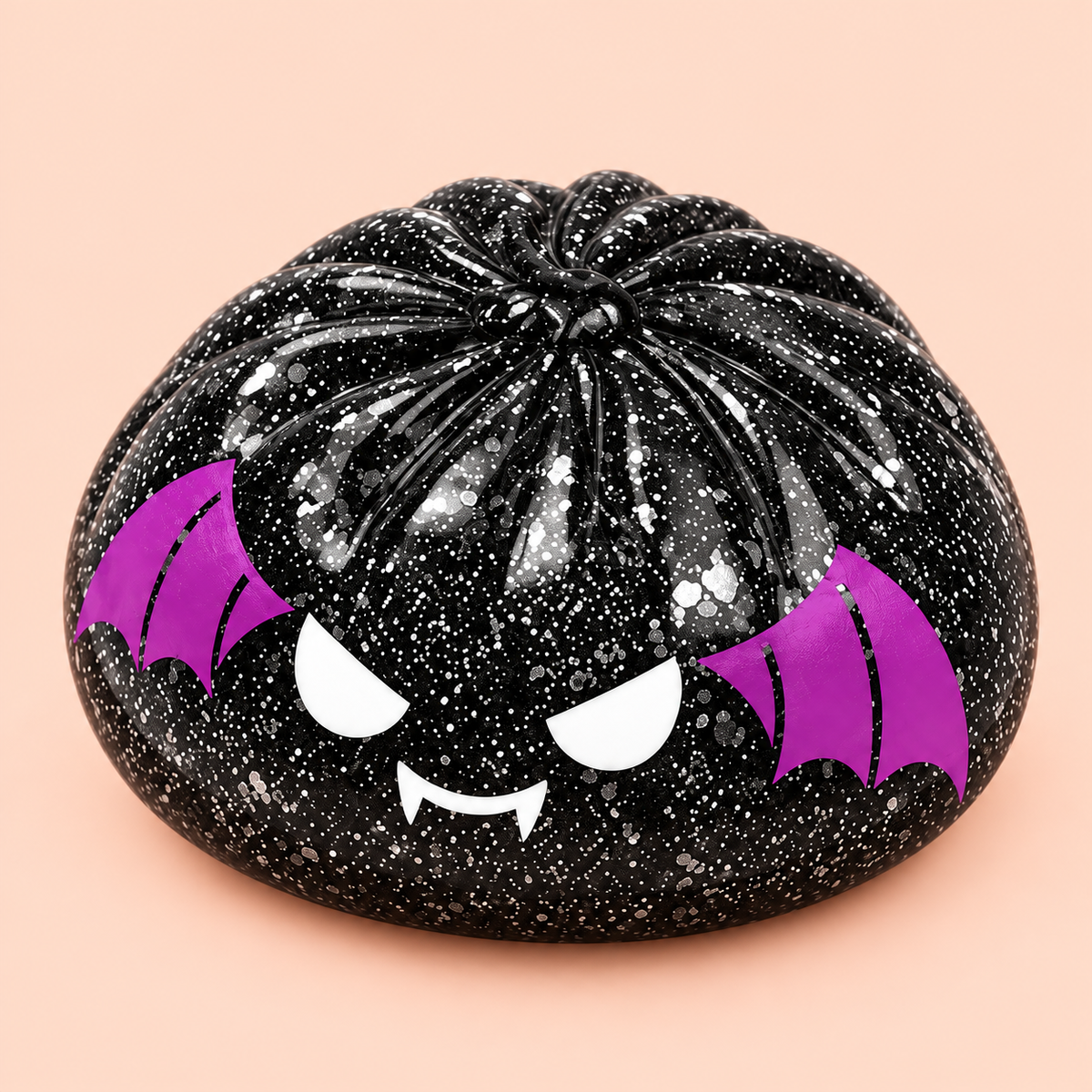 Close-up of black glitter Spooky Bat Squishy with purple wings and fangs