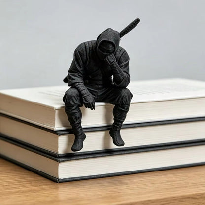 Thinking Ninja seated on a stack of books